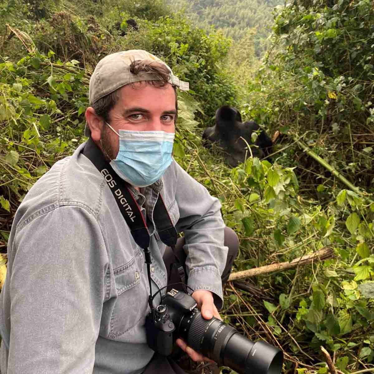 Tourist and gorilla in Rwanda.